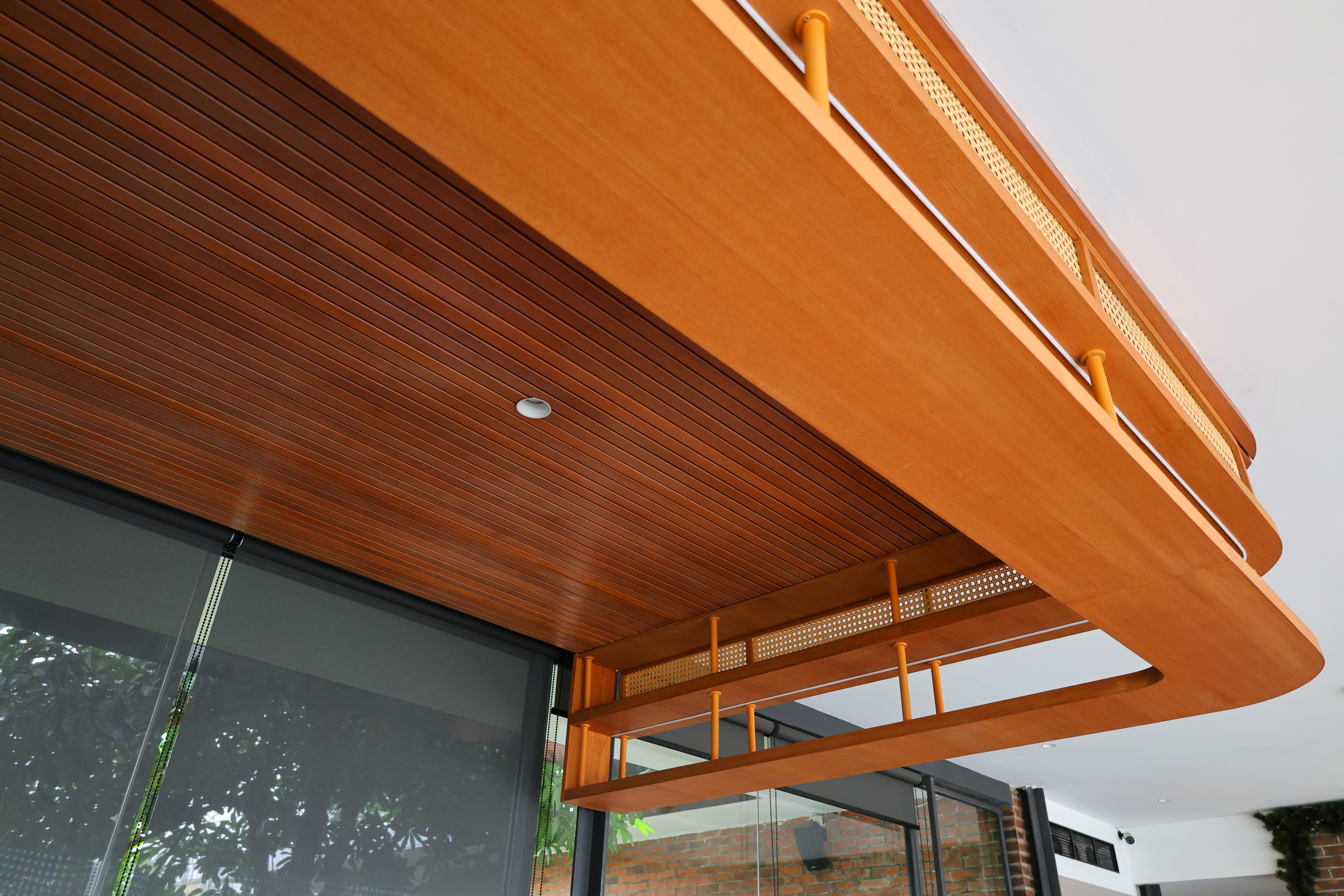 Exterior timber slat ceiling canopy installed over glass facade at BSteak Kelapa Gading by Reywood